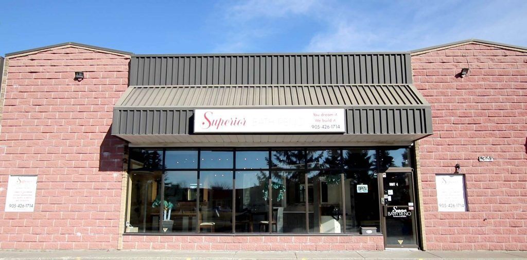 Superior Bath Reno storefront with large windows, signage displaying the brand name, and an "OPEN" sign, located at 31 Barr Rd., Ajax, showcasing a welcoming environment for bathroom renovation inquiries.