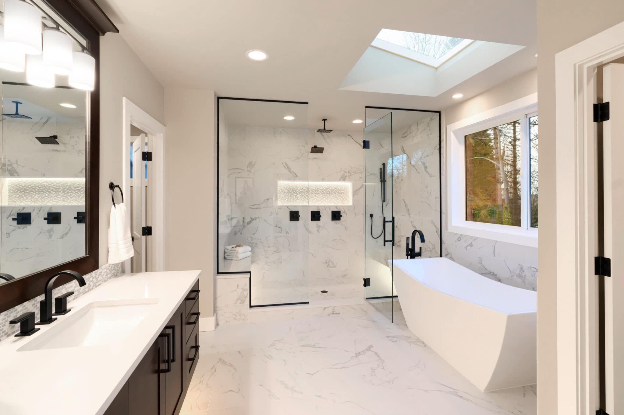 Modern bathroom renovation featuring a sleek glass shower, freestanding bathtub, elegant fixtures, and marble accents, showcasing Superior Bath's craftsmanship.