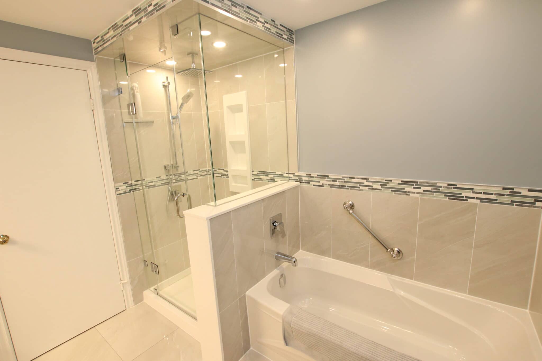 Modern bathroom renovation featuring a glass shower enclosure, a freestanding bathtub, and stylish tile accents, showcasing Superior Bath's craftsmanship.