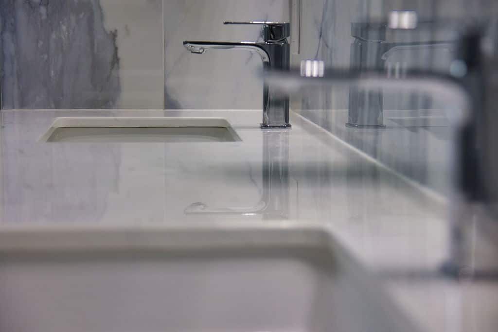 Modern bathroom sink with sleek chrome faucets and marble countertop, showcasing Superior Bath's custom renovation craftsmanship.