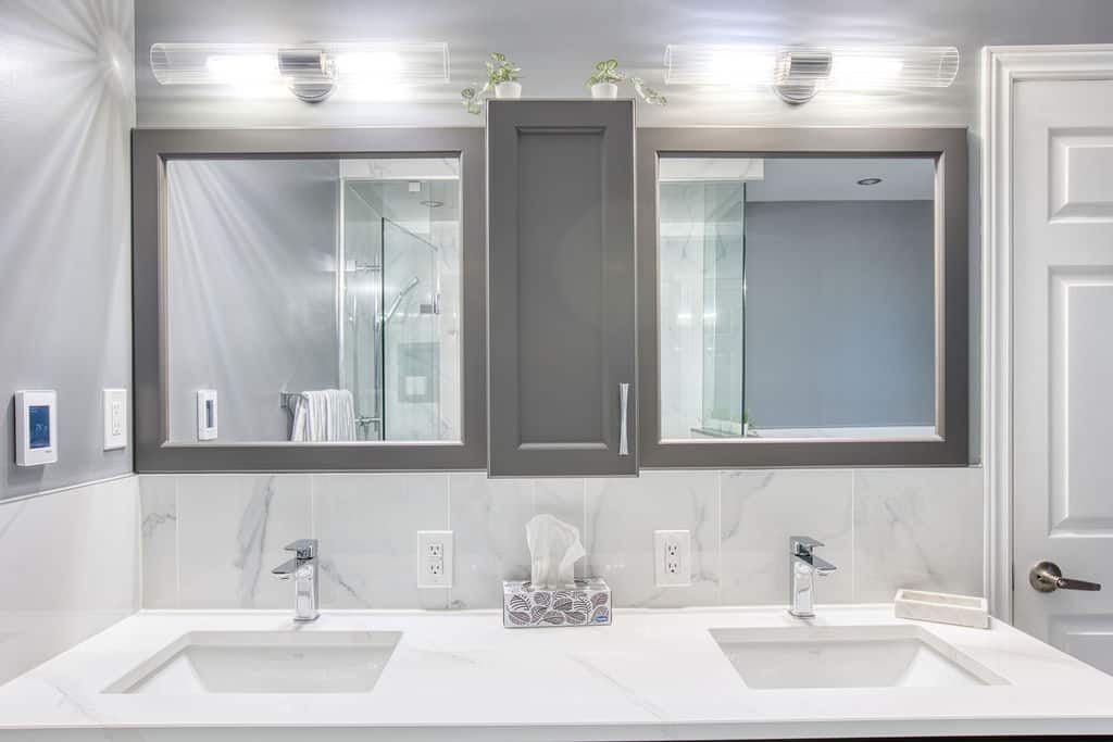 Modern bathroom vanity with dual sinks, stylish gray cabinetry, and elegant fixtures, showcasing Superior Bath's custom renovation work.
