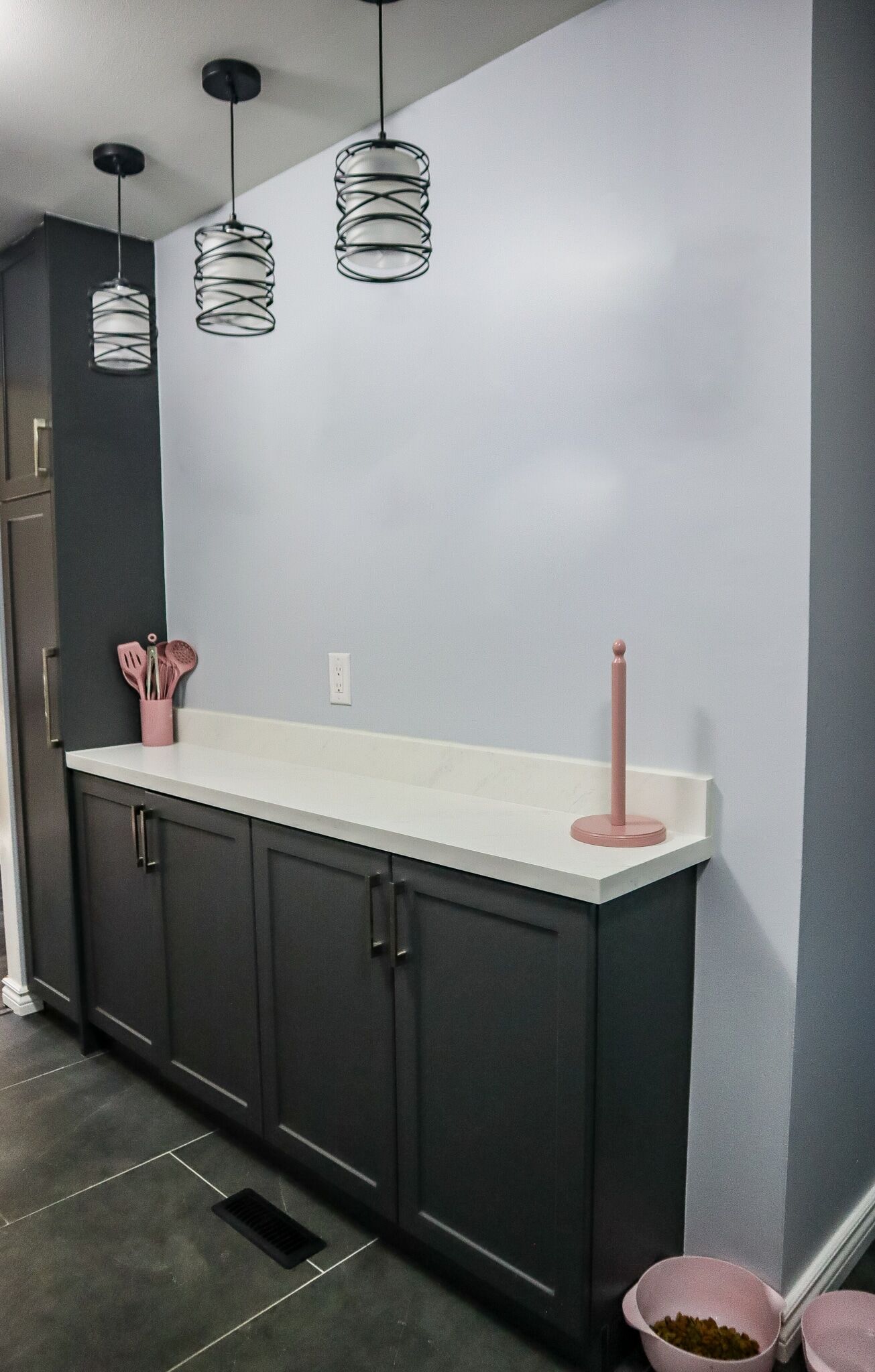 Modern kitchen renovation featuring gray cabinetry, white countertop, and decorative pink accents, highlighting Superior Bath's design style.