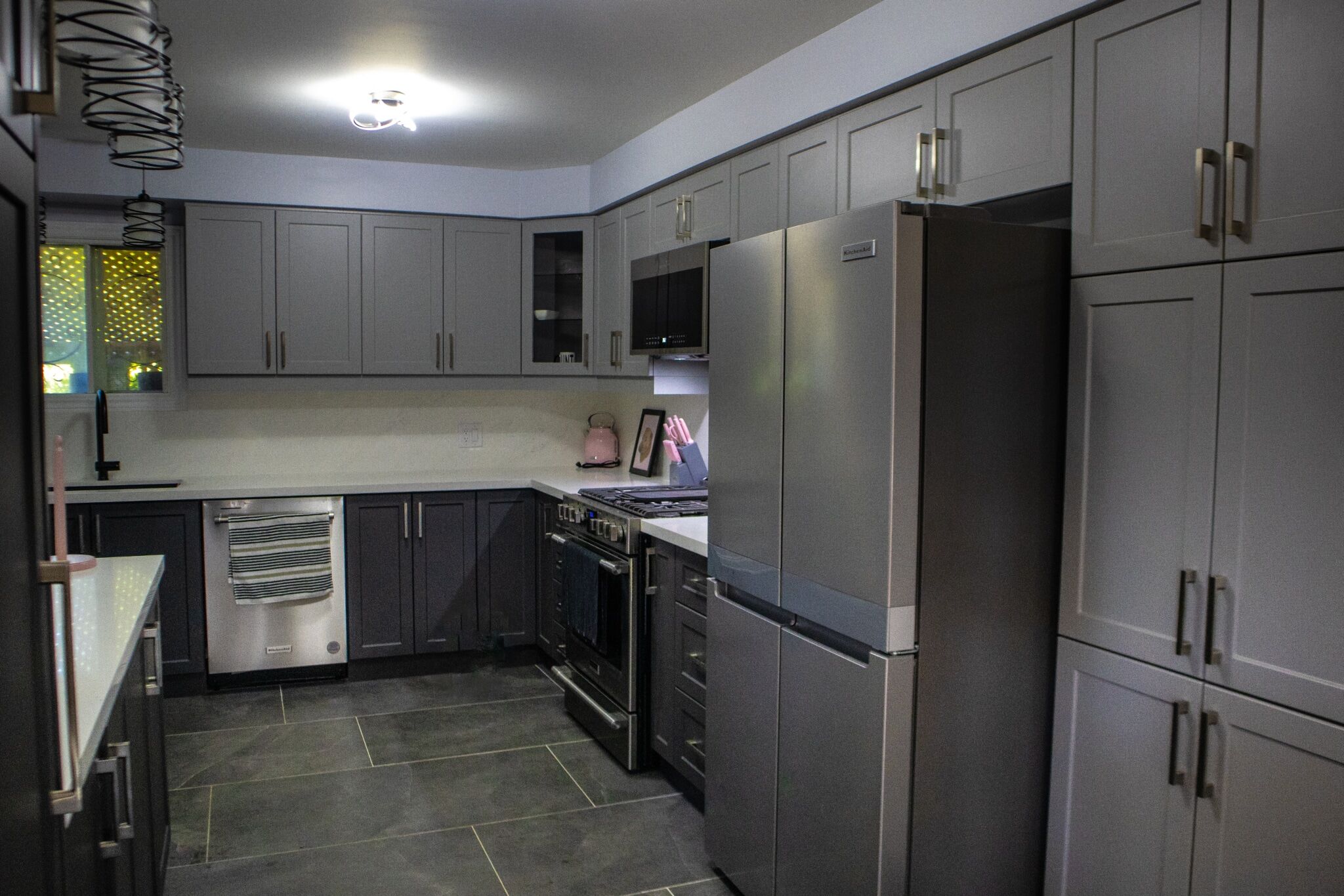 Modern kitchen renovation featuring gray cabinetry, stainless steel appliances, and a sleek countertop design by Superior Bath.