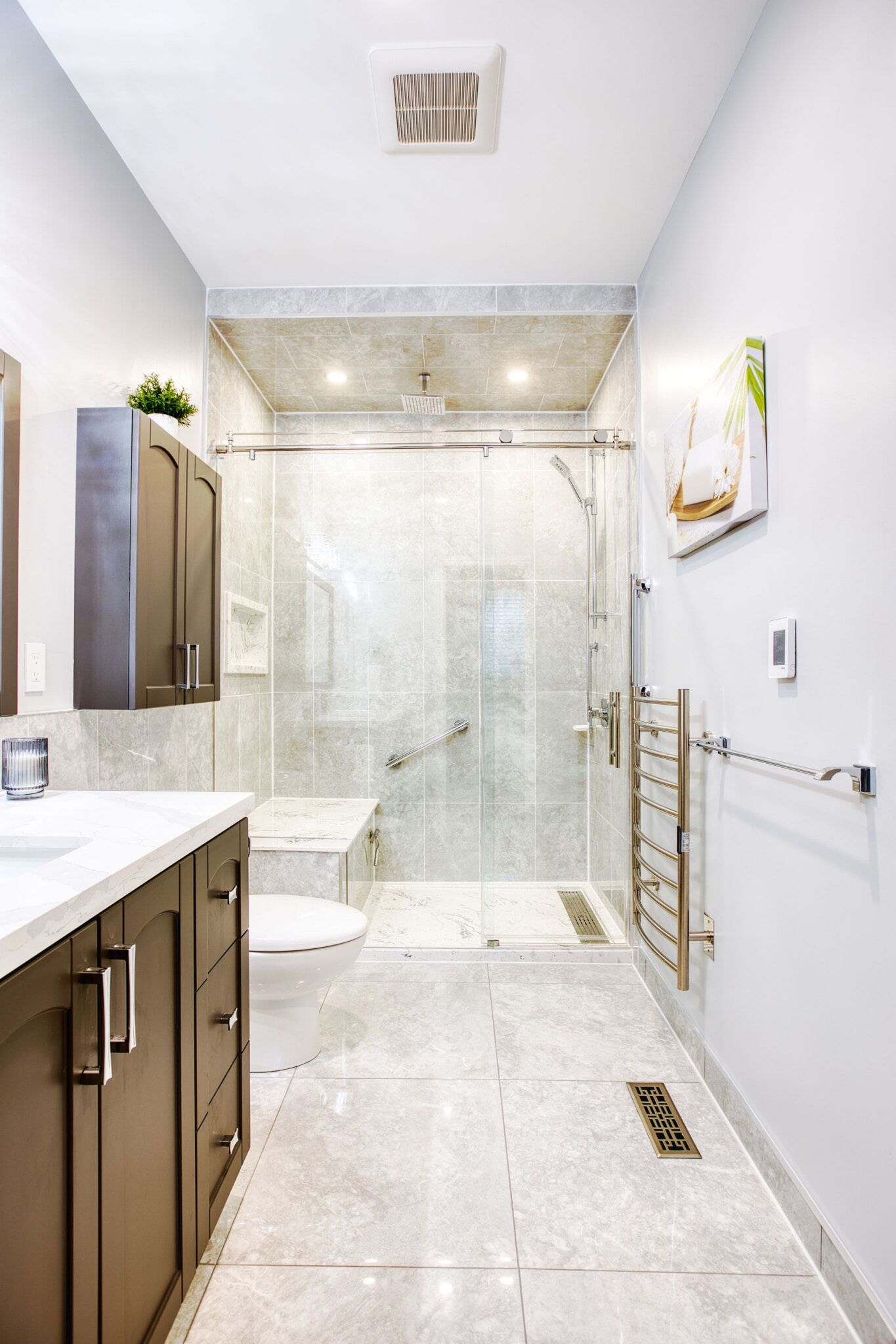 Modern bathroom renovation featuring a glass shower enclosure, sleek cabinetry, marble countertops, and contemporary fixtures, showcasing Superior Bath's craftsmanship.