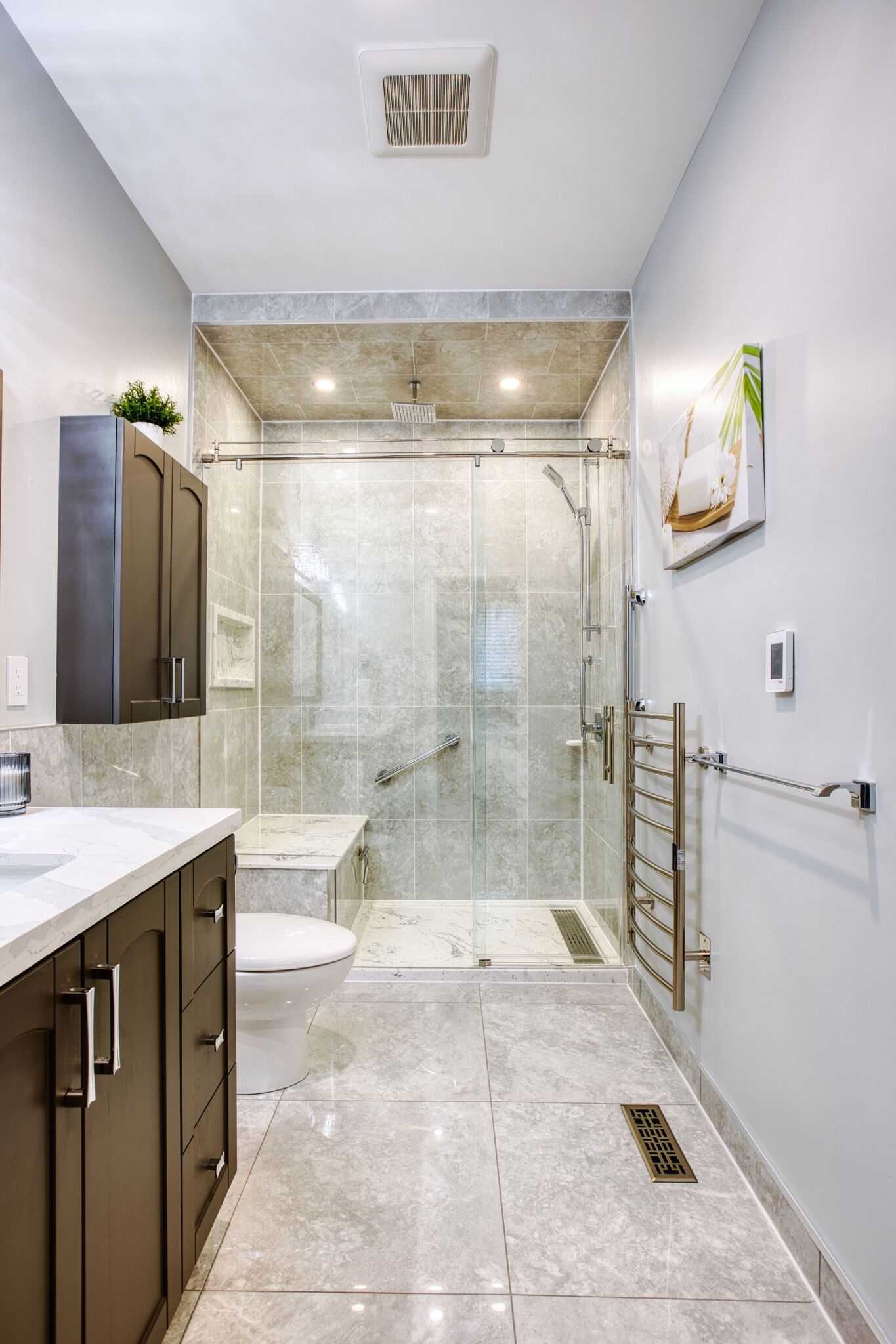 Modern bathroom design featuring a glass shower enclosure, marble tiles, dark cabinetry, and contemporary fixtures, showcasing Superior Bath's custom renovation work.